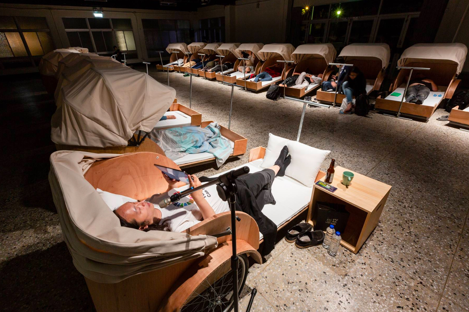 Audrey Tang reading during Sleep Series by Shu Lea Cheang and Matthew Fuller.  Beds designed by B. K. Yeh, 2018, C-LAB Taiwan, 2018-9.
